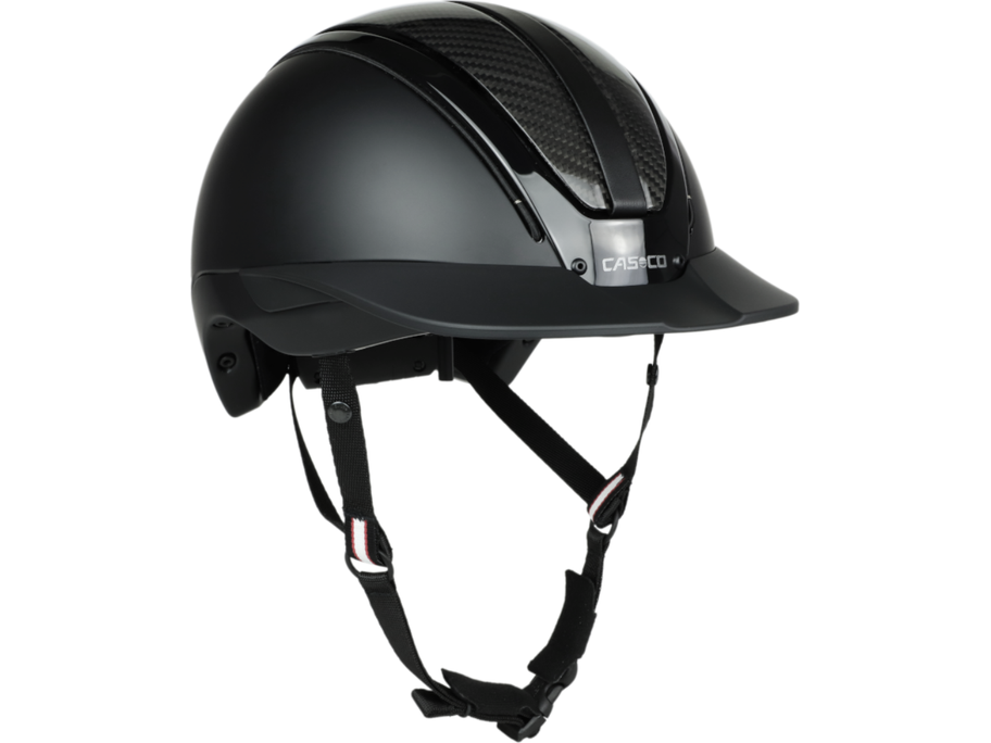 Der Reithelm Casco DUELL One Carbon ist der Inbegriff von minimalistischer Raffinesse – die makellose schwarze Optik, kombiniert mit edlen Karbonelementen und veganem Leder, definiert zeitlose Eleganz neu